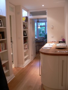 Corridor lined with storage units and bookcases