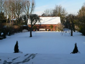 View of barn outhouse from the dining terrace outside the house in the snow