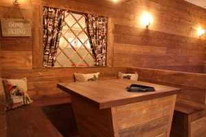 Vintage wall sconce lighting around banquette seating area