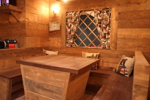 Banquette seating area with ski chalet faux window