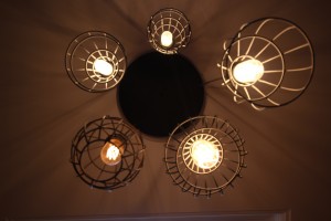 Cage chandelier lighting over pool table